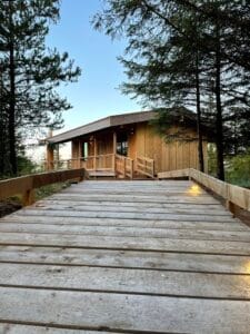 Boardwalk leading to a wooden building at dusk