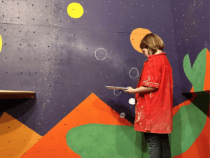 Youth painting a mural