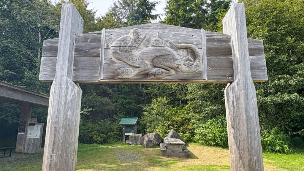 Carved cedar sign of a Wasco, a Haida Supernatural Being, at the head of the Spirit Lake trail
