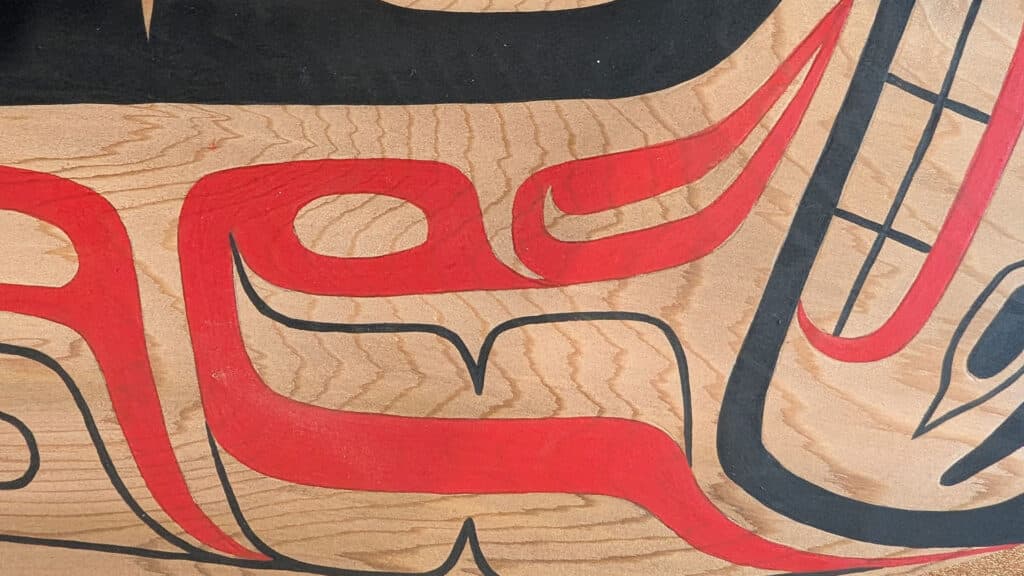 A close up of a painted cedar canoe paddle